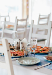 beautifully laid tables with glasses and appliances at morning in restaurant. Empty glasses