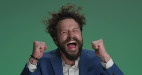 crazy businessman holding fists in the air, screaming and cheering victory, being the winner, making funny and dynamic, energy faces on green background - Powered by Adobe