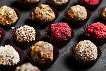 Various homemade raw vegan truffles or energy balls such as almonds and cocoa, dark chocolate and hazelnut butter
