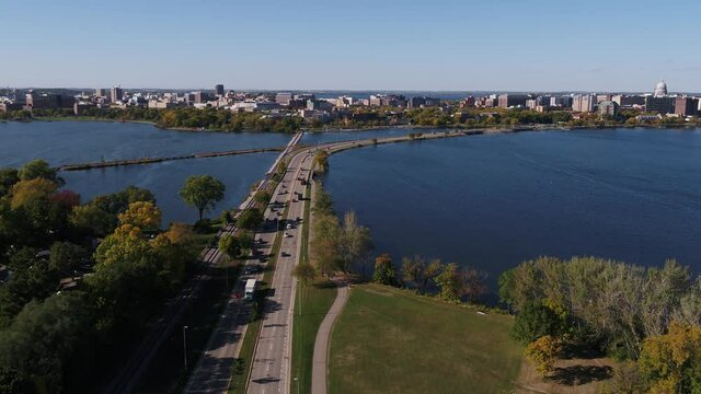 Flying Over John Nolen Drive towards Downtown Madison, Wisconsin Surrounded by Fall Colors (Drone - Push In & Tilt Towards Downtown)