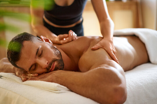 Relaxed man having back massage in the spa salon
