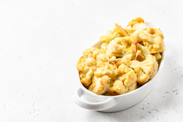 Buffalo baked cauliflower in baking dish. Space for text.