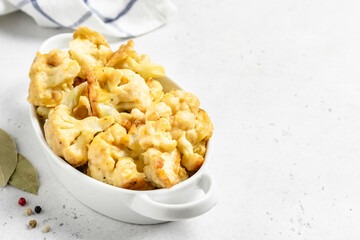 Buffalo baked cauliflower in baking dish. Space for text.