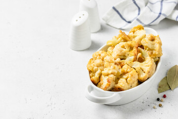 Apple cider battered cauliflower in baking dish. Space for text.