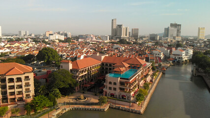 Fototapeta na wymiar Melaka, Malaysia. Aerial view of city homes, river and skyline from drone on a clear sunny day.