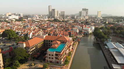 Melaka, Malaysia. Aerial view of city homes, river and skyline from drone on a clear sunny day.