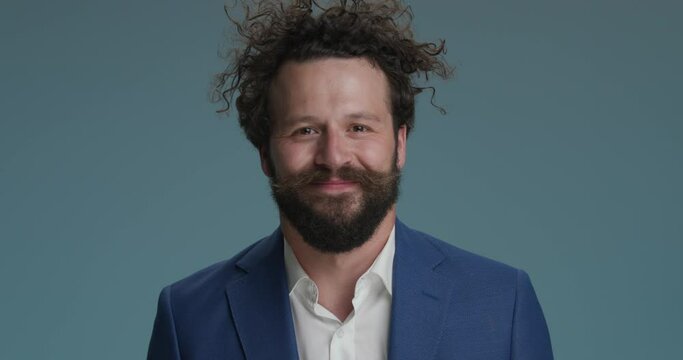 funny businessman on blue background talking in a crazy manner, making chatty hands gesture and having fun on blue background