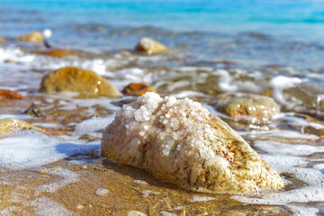 Close up of salt background. Natural salt. Dead Sea salt mineral natural formations. Salt crystals from Dead sea. View of Dead Sea coastline. Texture of Dead sea. Salty seashore