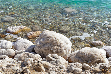 Close up of salt background. Natural salt. Dead Sea salt mineral natural formations. Salt crystals from Dead sea. View of Dead Sea coastline. Texture of Dead sea. Salty seashore