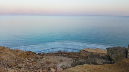 View of Dead Sea coastline. Salt crystals at sunset. Texture of Dead sea. Salty sea shore. Landscape Dead Sea coastline in summer day,  failures of the soil