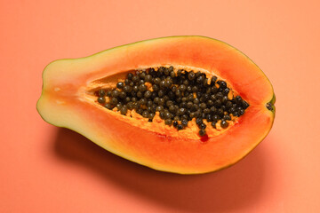 Papaya fruit on a orange background. Half papaya.