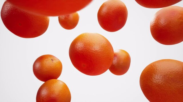 Grapefruits. Сamera flyby slowmo b-roll on white background. Bullet time close-up arc shot