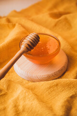 Thick sweet tasty honey in a bowl. Wooden spoon for honey. Sugar substitute. Natural sweetness.