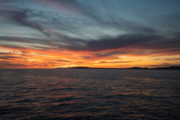 Calm golden sunset on open water while sailing the atlantic ocean