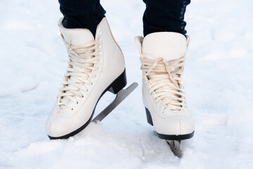 Woman skating at ice. Close up of feet with ice skates on.