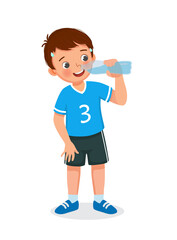 Cute little boy drinking fresh water from a bottle feeling thirsty after doing sport exercise