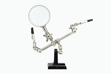 Old soldering iron stand with magnifying glass isolated on a white background