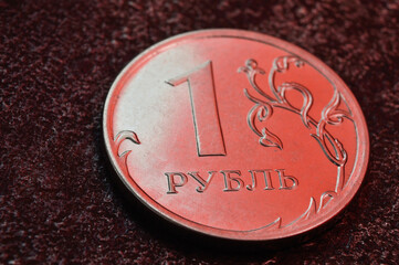a Russian one ruble coin lies on a dark metal background. close-up