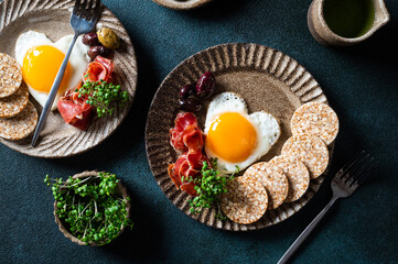Breakfast on Women's Day - fried eggs in the shape of a heart and olives. Healthy breakfast. Rice cakes with eggs and hamon. Romantic breakfast. Top view.