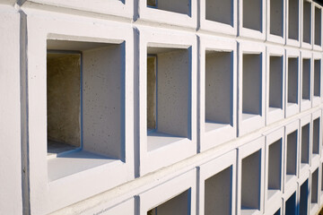Wall with new empty cremation niches. Row with empty graves for cinerary urns. Cremation service,...