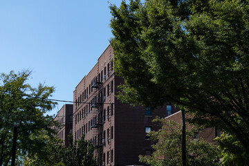 Row of Generic Old Brick Apartment Buildings with Fire Escapes in Astoria Queens of New York City