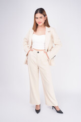 Portrait of young beautiful businesswoman wearing suit in white background studio..