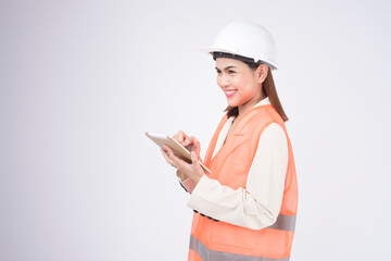 a woman engineer wearing a protective helmet over white background studio