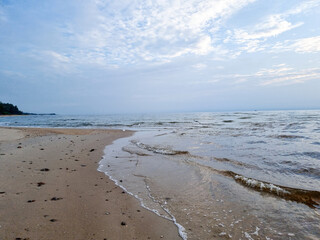 beautiful golden sand beach sunrise fresh sea breeze summer vacation. blue sky and white clouds.