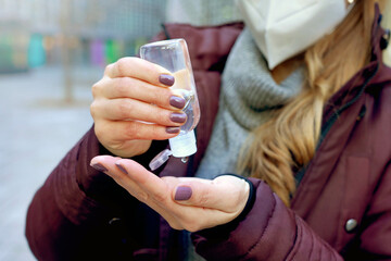 Close up of woman hands washing with alcohol gel to eliminate bacteria and viruses outdoor