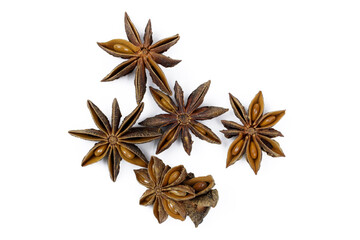 Fototapeta premium Anise stars on a white background top view. Dry spices for culinary dishes. Dried anise stars with seeds.