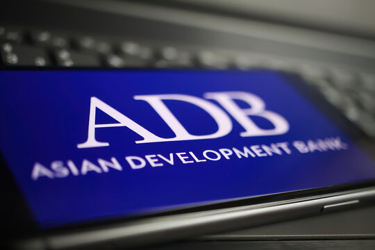 Viersen, Germany - January 9. 2022: Closeup of mobile phone with logo lettering of adb asisan development bank on computer keyboard