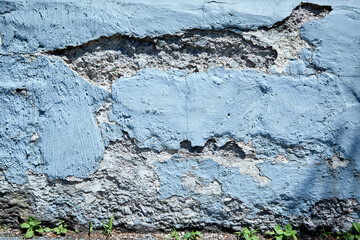 Large Missing Section of Blue Cement Wall