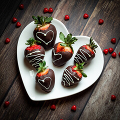 Top down view of a heart shaped plate filled with chocolate covered strawberries