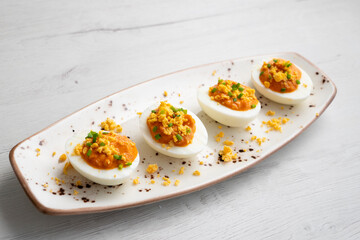 Stuffed eggs with tomato sauce and tuna. Spanish traditional tapas.