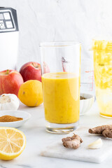 A glass of freshly made turmeric detox elixir, ready for drinking.