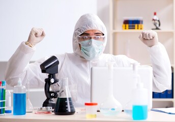 The young handsome chemist working in the lab