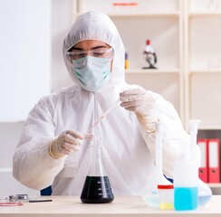 The young handsome chemist working in the lab