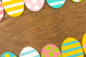 Colorful Easter egg with double side border on old wood background, flat lay design, top view with...