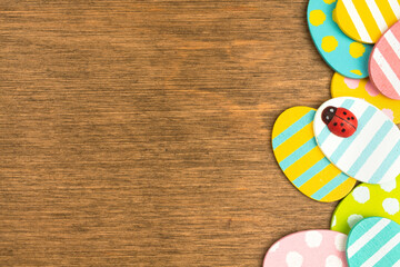 Colorful Easter eggs border, old rustic wood background, flat lay design, top view with copy space photo