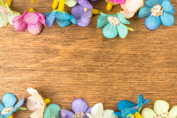 Happy easter concept, colorful spring holiday flower decoration border, old rustic wood background. Flat lay design, top view with copy space photo
