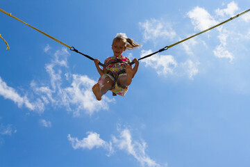 Smiling little girl on an amusement park ride