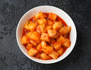Korean fermented Radish Kimchi in white bowl. Healthy food.