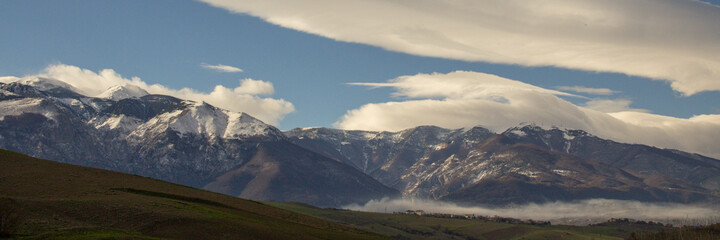 panorama view of the Majella mountain in Abruzzo Italy, with blue sky and clouds also called the little Tibet. Banner 