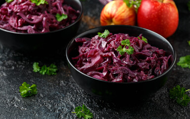 Braised Red Cabbage with apples and redcurrant in black bowl