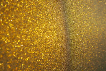 Gold close up. Golden glitter texture background. Sparkling glitter wrapping paper with sequins and...