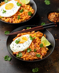 Kimchi fried rice with fried egg and bacon. Korean food