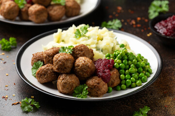 Homemade Swedish Meatballs with cranberry relish Sauce, potato mash and peas