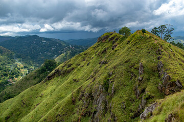 Fototapeta na wymiar Green vibrant rocky mountains with dark clouds in Sri Lanka
