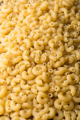 pile of pasta, closeup food background, diet and food concept, taken in shallow depth of field h copy space