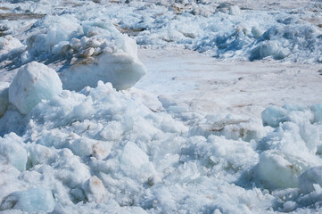 Melting ice on the river in spring. Ice drift time. Natural structure.